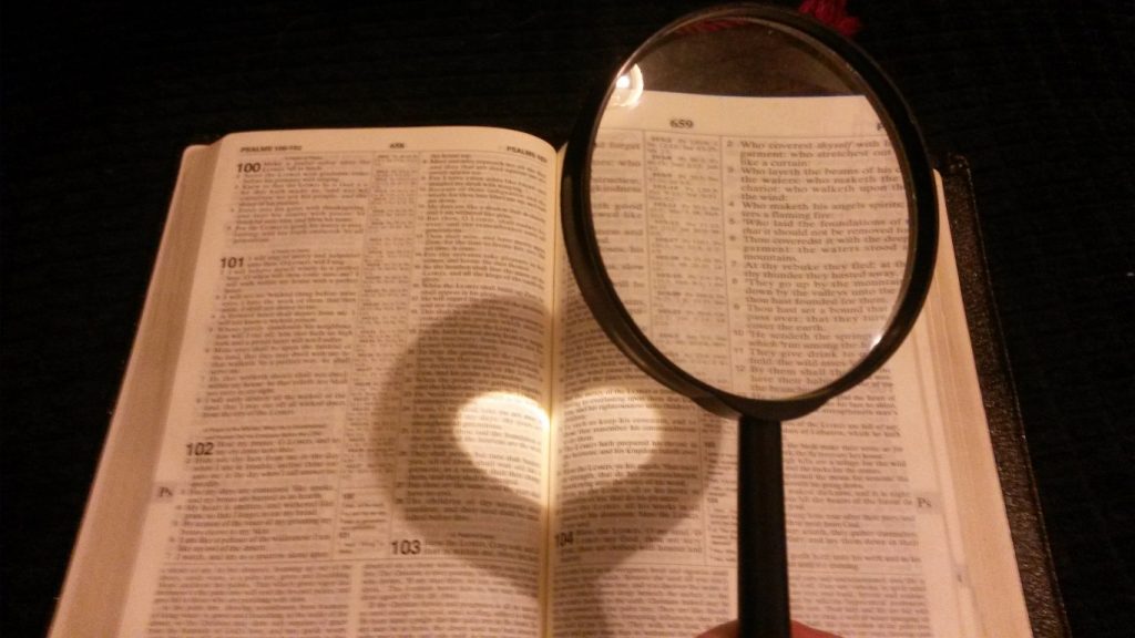 Pic of magnifying glass over a book