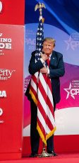 President Trump hugging the American Flag