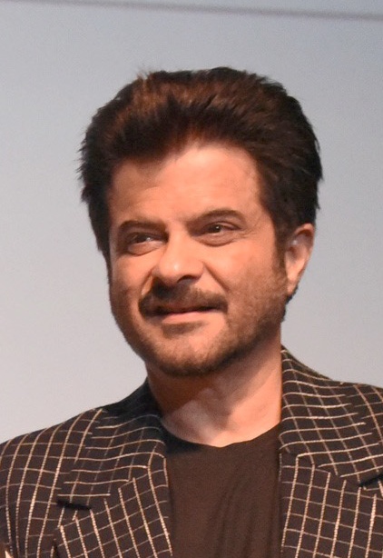 Hindi film actor Anil Kapoor in a brown blazer and. abrown tshirt. 